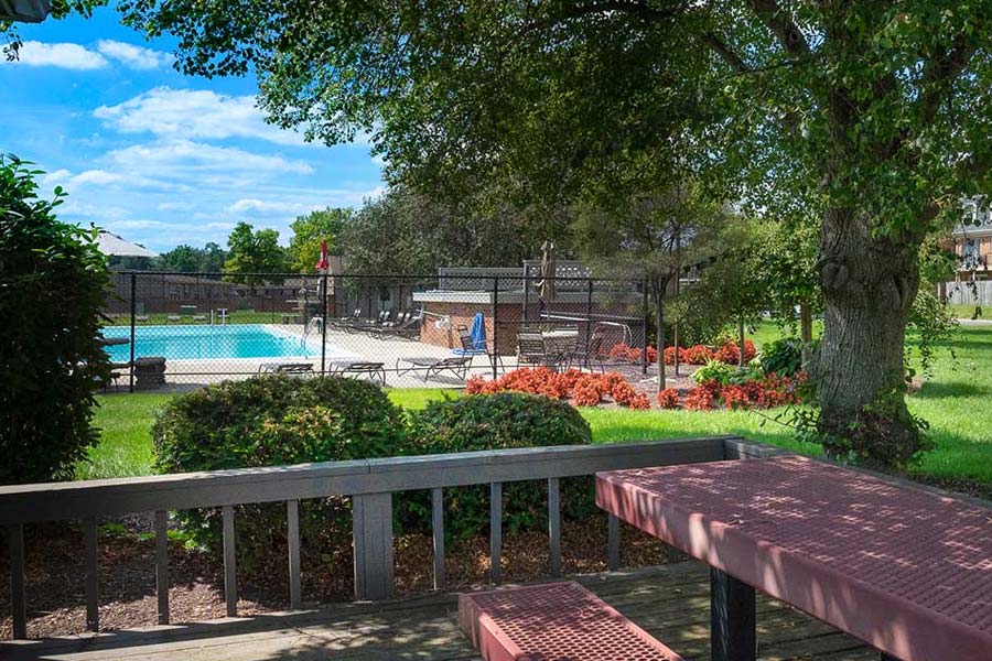 Yorktown Colony Apartments seating area with pool in background